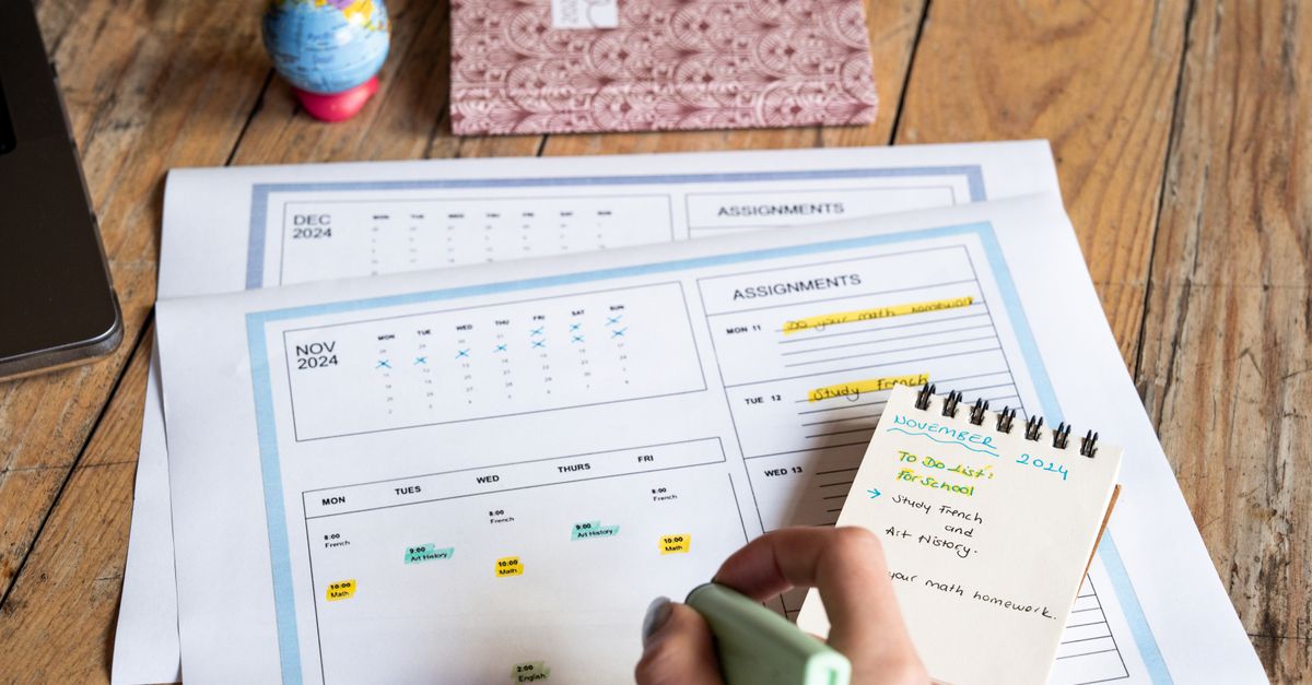 A family reviewing a grocery budget planner on a tablet at a kitchen table.